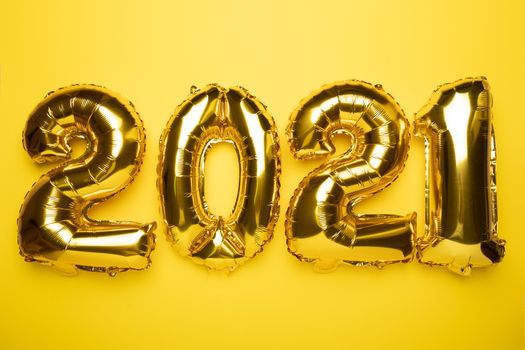 2021 concept new year from golden foil balloon stock photo