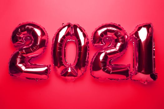 2021 concept new year from red foil balloon numbers on red background