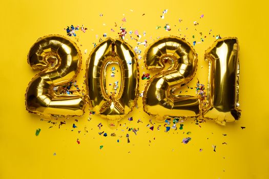 2021 concept new year from golden foil balloon and confetti stock photo