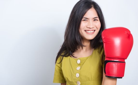 Portrait Asian beautiful young woman standing smile in boxing gloves and looking to camera, shoot the photo in a studio on a white background, There was copy space