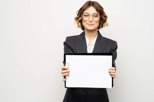 Business woman with a folder of documents on a light background cropped view and shirt suit. High quality photo