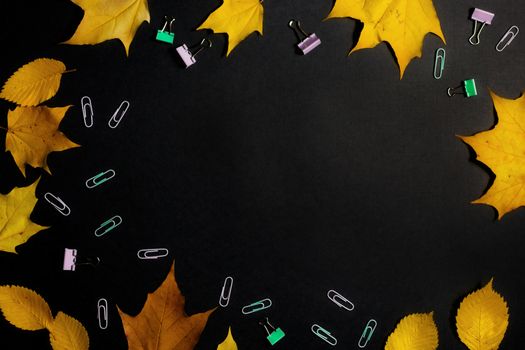 .Autumn fallen foliage and stationery on black background