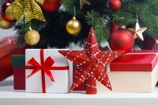 Christmas gifts and red decorative star on white background