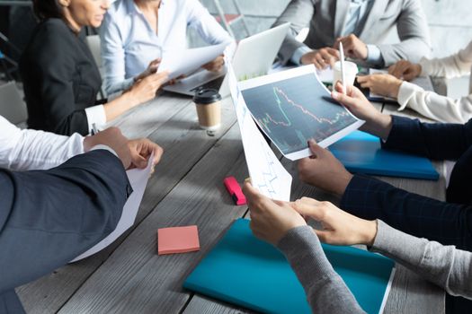 Business corporate management planning team concept, people sitting around office table and working with financial data reports