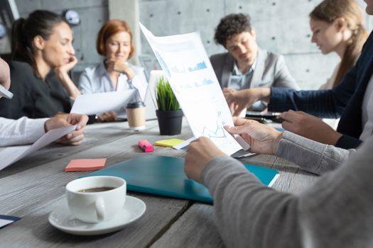 Business corporate management planning team concept, people sitting around office table and working with financial data reports