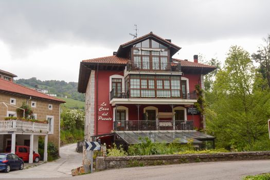 Regules, Spain, May 2018: Street view on hotel and bed and breakfast Casa Del Puente next to gandara river