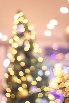 abstract defocused background of decorative christmas light in shopping mall, beautiful bokeh for background, sweet tone filter effect