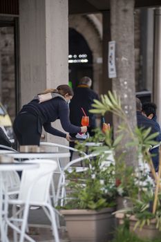 terni,italy october 27 2020:bartender bringing aperitif to the table