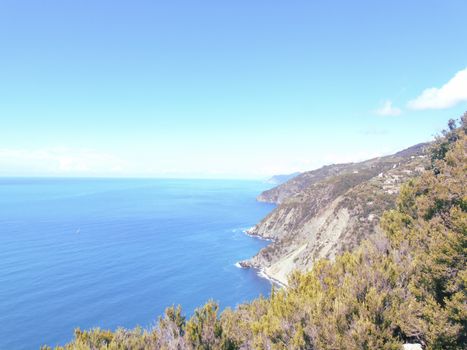 Liguria, Italy - 06/15/2020: Travelling around the ligurian seaside in summer days with beautiful view to the famous places. An amazing caption of the water and the sky reflection with blue sky.