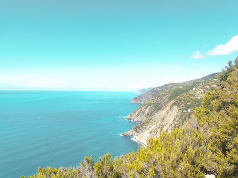 Liguria, Italy - 06/15/2020: Travelling around the ligurian seaside in summer days with beautiful view to the famous places. An amazing caption of the water and the sky reflection with blue sky.