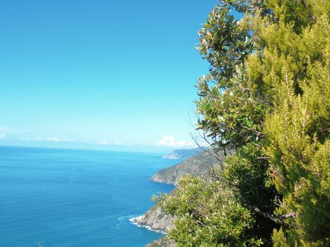 Liguria, Italy - 06/15/2020: Travelling around the ligurian seaside in summer days with beautiful view to the famous places. An amazing caption of the water and the sky reflection with blue sky.