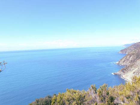 Liguria, Italy - 06/15/2020: Travelling around the ligurian seaside in summer days with beautiful view to the famous places. An amazing caption of the water and the sky reflection with blue sky.