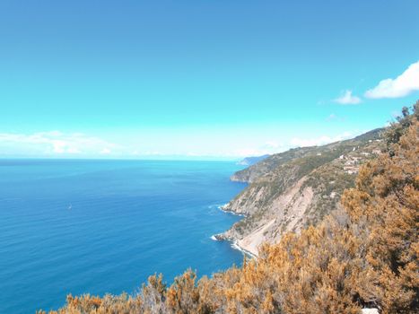 Liguria, Italy - 06/15/2020: Travelling around the ligurian seaside in summer days with beautiful view to the famous places. An amazing caption of the water and the sky reflection with blue sky.