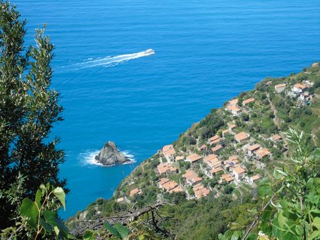 Liguria, Italy - 06/15/2020: Travelling around the ligurian seaside in summer days with beautiful view to the famous places. An amazing caption of the water and the sky reflection with blue sky.