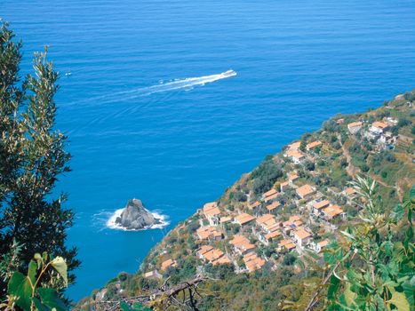 Liguria, Italy - 06/15/2020: Travelling around the ligurian seaside in summer days with beautiful view to the famous places. An amazing caption of the water and the sky reflection with blue sky.