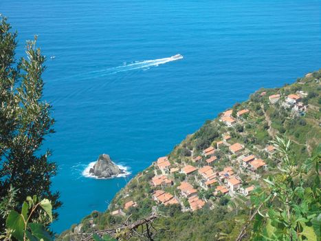 Liguria, Italy - 06/15/2020: Travelling around the ligurian seaside in summer days with beautiful view to the famous places. An amazing caption of the water and the sky reflection with blue sky.