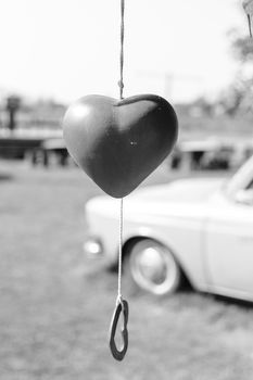 Black and white Heart-shaped bell hanging on the tree for Valentine's Day.