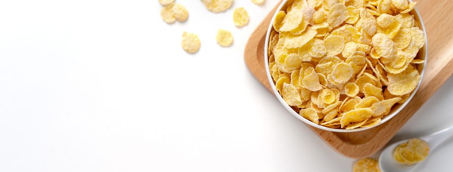 Top view of corn flakes bowl sweeties with milk and orange on white background, flat lay overhead layout, fresh and healthy breakfast design concept.