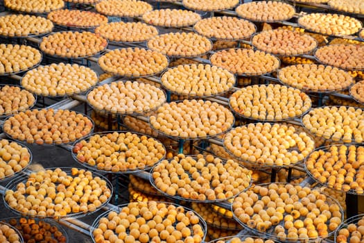 Making process of sun exposuring drying peeled dried persimmon in a sieve, autumn preserved food concept.