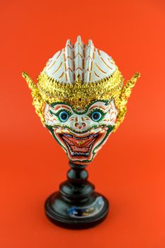 Thailand actor's mask isolated on red background.