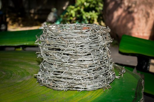 A soll of barbed wire on the table.