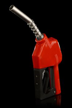 An isolated over a black reflective background image of a modern day red gas pump nozzle.