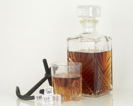 An inviting glass of Scotch on the rocks over an of white background.