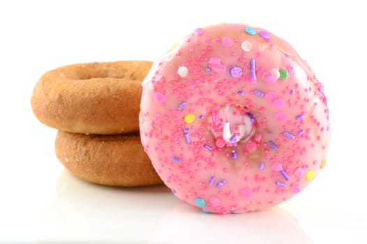 An isolated group of freshly baked donuts over a white background.