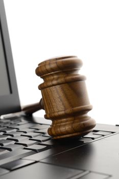 A judges gavel on a laptop to illustrate concepts of online legal services.