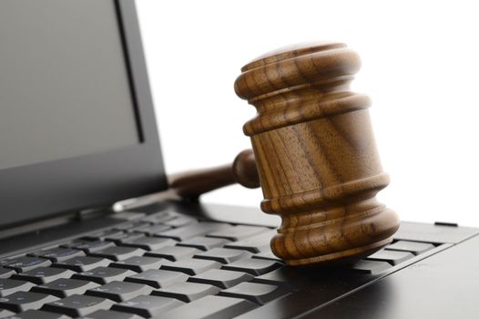 A judges gavel on a laptop to illustrate concepts of online legal services.