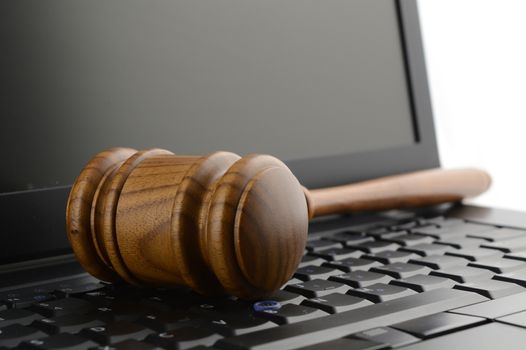 A judges gavel on a laptop to illustrate concepts of online legal services.