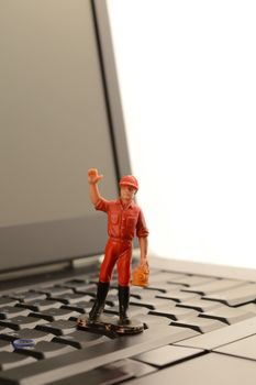 A little man waves from on the laptop.