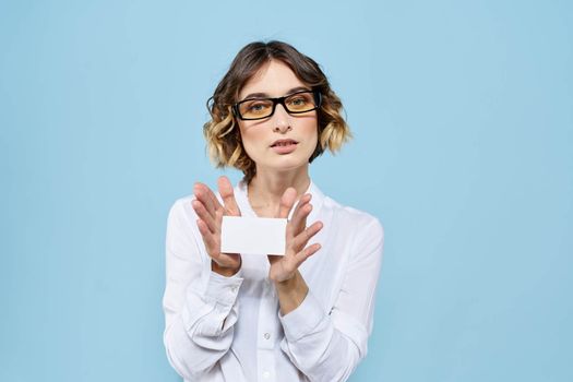 Woman wearing business card glasses in hands on blue background Copy Space cropped view. High quality photo