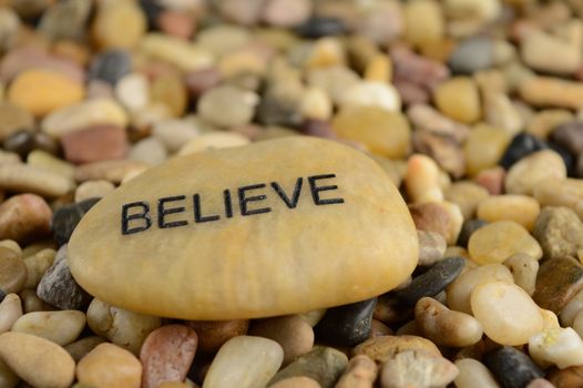 A stone with the word Believe engraved on it for affirmation purposes.