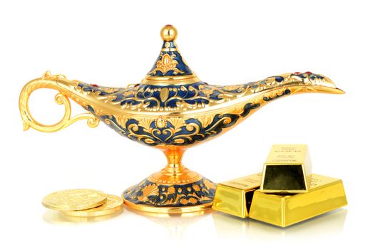 An isolated over white genie lamp with gold riches.