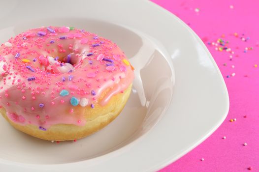 A closeup of a freshly baked and decorated donut ready for the first bite.
