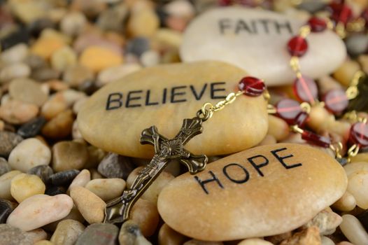 Worded stones with a Rosary to bring meaning to the faith of Jesus Christ.