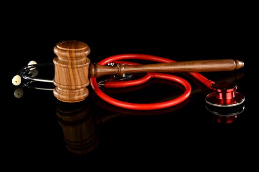 Medicine and Law come together here with a stethoscope and gavel for various conceptual uses.