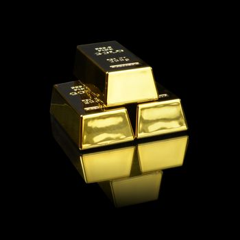 A stack of pure gold bullion bars over a black background.