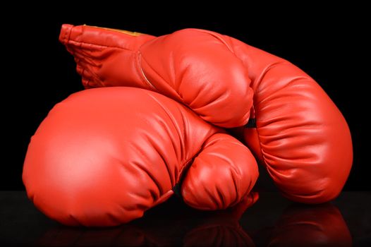 A pair of red boxing gloves to highlight the competitive sport.