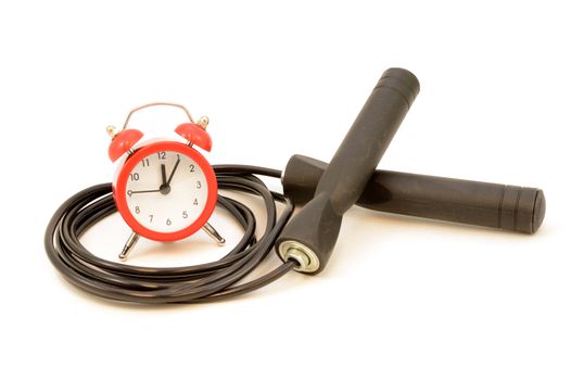 An isolated jump rope for skipping exercises with a red alarm clock.
