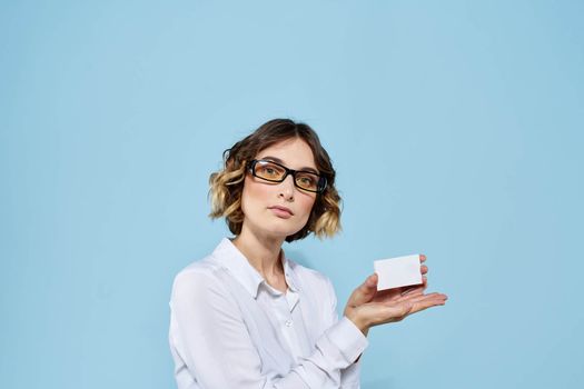 Woman wearing business card glasses in hands on blue background Copy Space cropped view. High quality photo