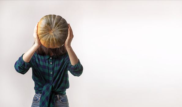 Facelaess woman is holding pumpkin. Concept photography with copy space.