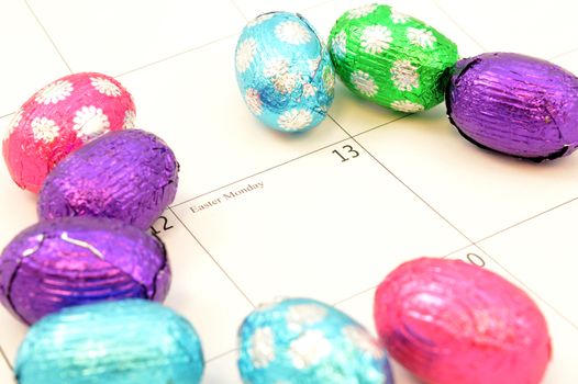 Closeup of Easter Monday marked out on the calendar with some chocolate eggs.