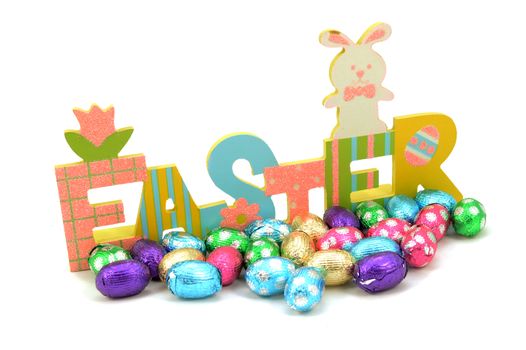 An isolated over white background image of an Easter sign with several chocolate eggs.