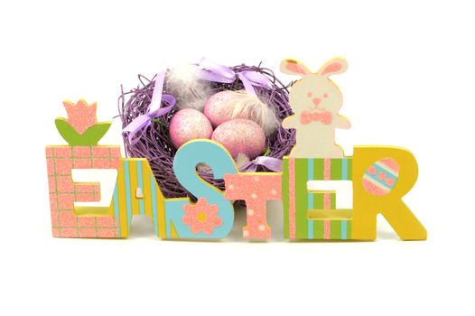 An isolated over white background image of a colorful Easter cutout sign with a purple nest and eggs for the holiday season.