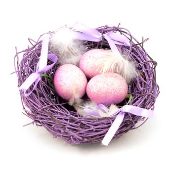 An isolated on white image of a festive purple nest full of eggs for the Easter holiday season.