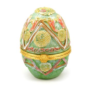 An isolated over white image of a decorative Easter Egg that opens up to store valuables inside.