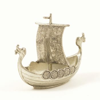 An isolated on white image of a small metal ship.
