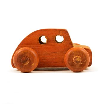 An isolated over a white background side view of a wood car toy.